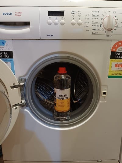 A front-loading washing machine with a bottle of mineral turpentine carefully--SO carefully--balanced in the door, after I checked the cap was screwed on tight
