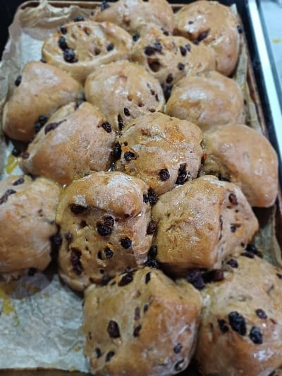 A bunch of buns, studded with sultanas and currants.